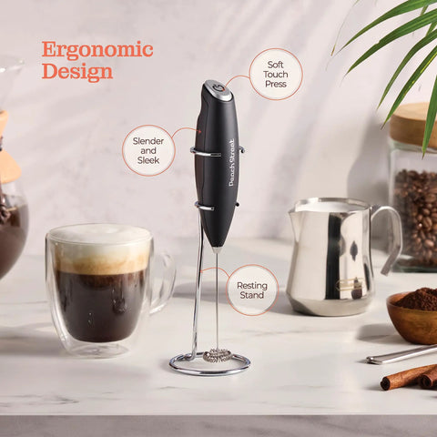 Game Changing Handheld Milk Frother Wand Battery Operated Stainless Steel Drink Mixer For Milk Coffee Lattes Cappuccino Frappe Matcha Hot Chocolate With Stand Gift, shown on stand next to coffee and milk accessories.