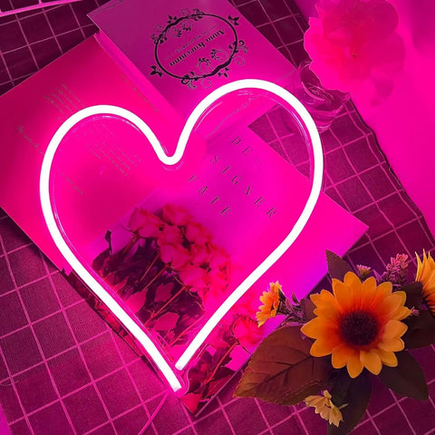 Pink Heart Neon Sign LED Light Up Wall Decor For Bedroom And Valentines Day Romance, Dimmable USB Powered Love Heart Light, 13.4 X 13 Inch on a table with flowers.