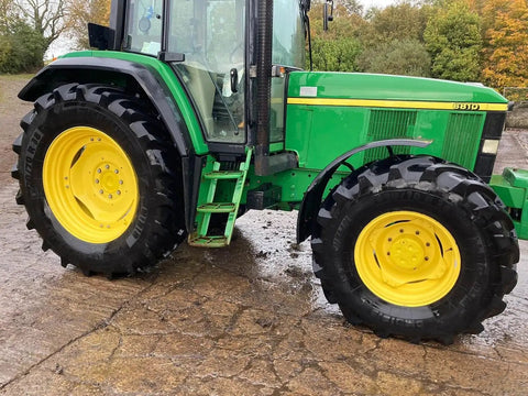 Green tractor with large tires parked on a concrete surface, suitable for cleaning with Touchless Heavy Equipment Cleaner One Step Detergent Soap Concentrate Foam For Construction Gear And Work Trucks No Brushing Commercial Grade Auto Foam Cleaner Dilutable Easy Rinse One Gallon.