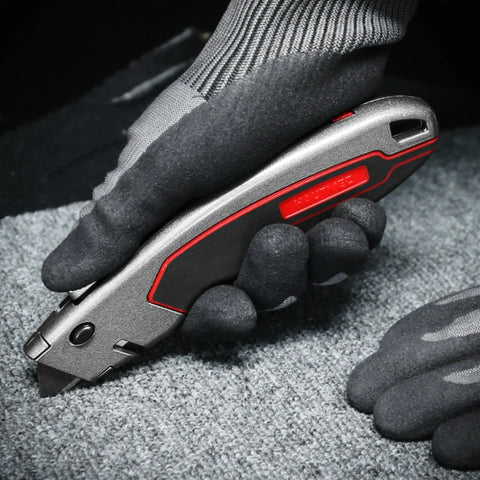 Heavy Duty Box Cutter Retractable Knife With 2 In 1 Cutting Modes, Auto Retracting Safety Knife And 3 Position Lock, Zinc Alloy Build, Blade Storage, Includes 3 SK4 Blades For Tough Jobs held in gloved hand