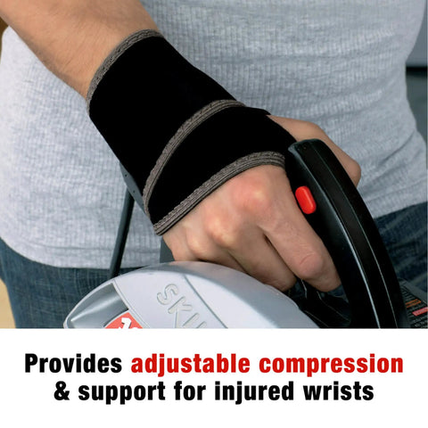 Person using a saw while wearing adjustable compression wrist support brace with moderate joint relief for weak sore or injured wrists
