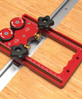Bulletproof Table Saw Feeder Roller With 160 Millimeter Anodized Aluminum Housing Dual Bearing Assembly Kickass Wide Rubber Tires For Smooth Slip Free Stock Feed Runs on a wooden surface.