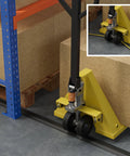 Warehouse floor with pallet jack and safety barrier.