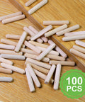 Quarter Inch By One And A Half Inch Wooden Dowel Pins 100 Pack In Natural Beech Warp Resistant Fluted Dowel Rods scattered on wood