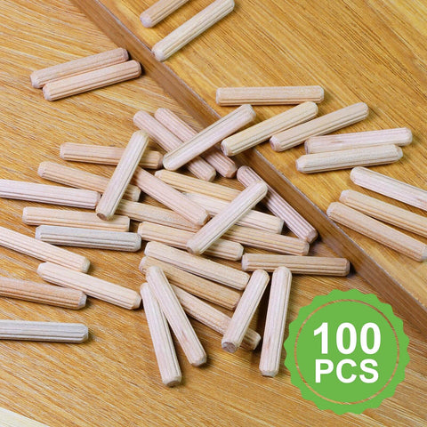 Quarter Inch By One And A Half Inch Wooden Dowel Pins 100 Pack In Natural Beech Warp Resistant Fluted Dowel Rods scattered on wood