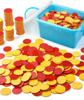 Two Sided Red And Yellow Counting Chips 1000 Piece Set in a blue storage container with scattered tiles on white surface.