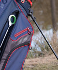 Jawz Golf Ball Retriever With 14 Foot Length And 18 Foot Reach stored in a golf bag on the course, visible rubberized grip