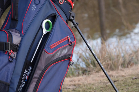 Jawz Golf Ball Retriever With 14 Foot Length And 18 Foot Reach stored in a golf bag on the course, visible rubberized grip
