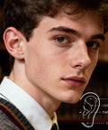 Close-up of man wearing Hypoallergenic Titanium Screw Back Earrings Set Three Pairs VVS1 Sparkling Moissanite Studs.