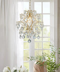 Top Tier Gold Crystal Raindrop Pendant Chandelier Featuring Durable Glass Tubes And Adjustable Chain Ceiling Light E26 Socket in bright room setting.