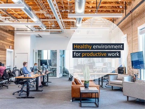 Modern office space with open seating and collaborative workspaces promoting a healthy environment for productive work.
