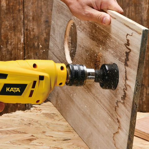 Person using drill with Beast Hole Saw Kit With 27 Piece Set Including 13 Blades From Three Quarter Inch To Five Inch Mandrels Hex Key Drill Bits And Storage Case Perfect For Soft Wood And Pvc Boards Great Gift For Diyers And Handymen on wooden board
