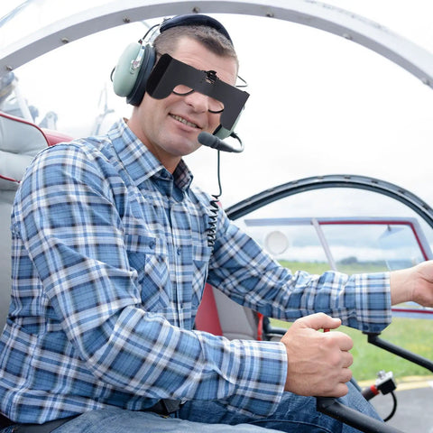Pilot wearing Clip On View Limiting Device For Pilot Training With Cloud Over Visor Shields inside cockpit.
