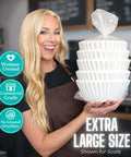Woman holding extra large commercial coffee filters 12.5 x 4.5 for 1.5-3 gallon brewers, no ground overflow, suitable for cafes.
