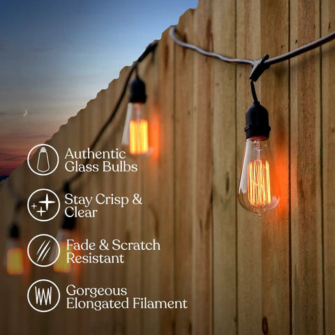 48 Ft Outdoor String Lights With 15 Vintage Filament Bulbs glowing against a wooden fence at sunset, highlighting glass bulb features.