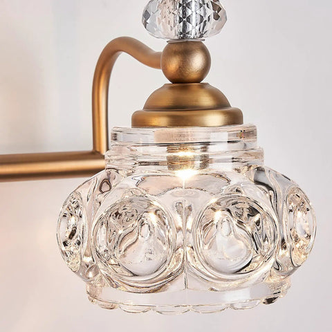 Close-up of glass shade on brass bathroom light fixture two light vanity lighting with G9 bulbs compatible energy saving vintage style