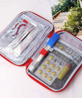Open Two Pack Grab And Go First Aid Bag Portable Medical Kit showing compartments and medical supplies inside red 600D Oxford bag.