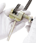 Close-up of 25H 62 Links Pro Grade Timing Chain Breaker Tool with chain in hands, used for Chinese ATVs, go-karts, dirt bikes.