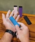 Reusable Skin File With Cover For Rock Climbing And Bouldering, Hand Callus Sander in use, multiple colors displayed, including Black.