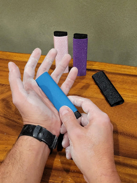 Reusable Skin File With Cover For Rock Climbing And Bouldering, Hand Callus Sander in use, multiple colors displayed, including Black.