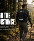 Man hiking with Hydration Backpack With 2L BPA Free Water Bladder Lightweight Daypack With Waist Pockets and Helmet Holder.