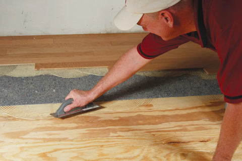 Pro Grade Flooring Underlayment Roll For Laminate Wood And Tile Sound Dampening Padding Compression Resistant Mat For Floating Glue Down Install Covers One Hundred Square Feet No Fuss Vibe Blocker Home Crew Staple being applied to subfloor.