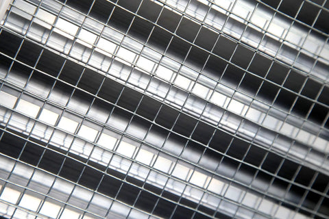 Close-up of heavy duty aluminum exterior gable louver vent for walls and crawlspace, weather resistant air grille with screen mesh.