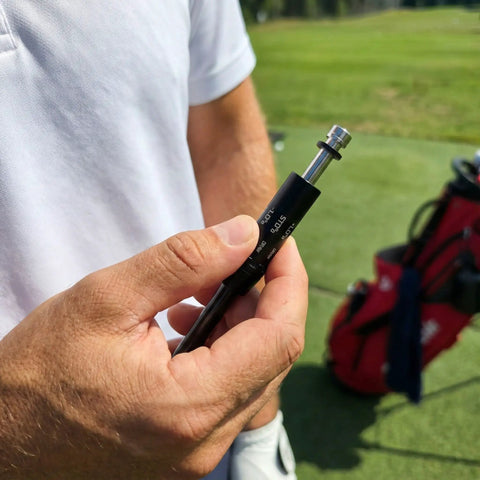 Close-up of a person holding a 335 Tip Golf Shaft Adapter Sleeve for Cobra Drivers Fits King F9 F8 F7 Fly Z Speedzone