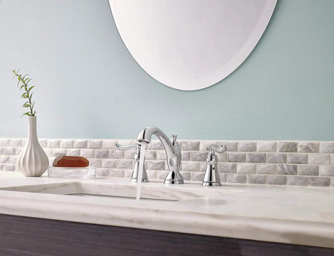 Linden Widespread Chrome Bathroom Faucet with Diamond Seal Technology installed on marble sink with mirror and decor.