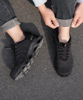 Lightweight Steel Toe Work Shoes For Men, Safety Sneakers Built To Handle The Grind With Cushioned EVA High Rebound Sole, Rugged Toe Protection, ASTM F2413 Certified, All Day Comfort, Colorful Design, Breathable And Durable, side view worn by person on street, showing sole and black design.
