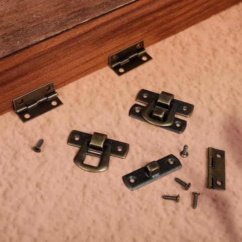 6 Piece Antique Bronze Latch And Hinges Set With Screws For Jewelry Boxes And Small Cabinets displayed on a wooden surface