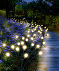 Bright Solar Outdoor Garden Spotlights Eight Head LED Landscape Lights illuminating a pathway at night, garden setting