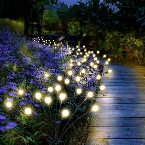 Bright Solar Outdoor Garden Spotlights Eight Head LED Landscape Lights illuminating a pathway at night, garden setting