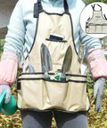 Person wearing garden apron with tools from 11-Piece Garden Tools Set For Women And Men With Heavy Duty Aluminum Hand Tools Apron And Storage Tote Bag