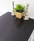 Table surface covered with Blackwood Peel And Stick Self-Adhesive Decor Film 17x78 Inch Roll 4-Pack Wood Grain Vinyl Wrap For Walls Cabinets Furniture And Shelves Easy DIY Makeover That Looks High End, featuring ebony wood grain design, with a plant and candlesticks on top.