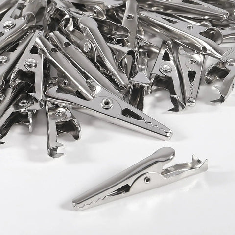 50 Pack 28mm Metal Alligator Clips For Lab And Battery Testing scattered on a white surface.