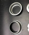 Rock Solid 2 Inch Cup Bottom Bracket Set featuring steel cups on black surface for one-piece cranks with bearings included