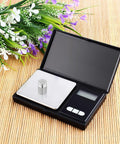 Digital scale with chrome-plated weight from 12 Piece Calibration Weights Set With Tweezers And Storage Box Pro Grade High Precision Steel Weights.