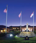 18 Watt LED Landscape Flood Light Fixture In Bronze Finish For Outdoor Use illuminating a monument at night with flags.