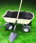 Shovel with Water Activated Quick Fix Tape for Easy DIY Repairs Seal Leaks Cracks And Tears on handle in front of garden cart with soil.