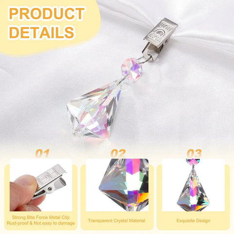 Close-up of Crystal Tablecloth Weights With Metal Clips And Rhinestone Pendant Ornaments on white fabric, showing crystal detail.