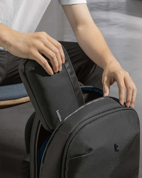 Slick Travel Cable Organizer Pouch With Double Compartments For Portable Charging Cords showing in a black backpack.