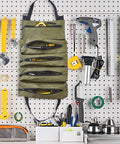 Heavy Duty Tool Roll Up Bag Portable Organizer For Mechanics Electricians And Repair Pros Waterproof Oxford Cloth Zipper Pouch Green Durable Tool Storage Case For Home Shop And On The Go hanging on a workshop pegboard.