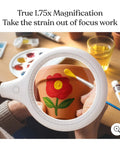 LightView Pro Flex 2 in 1 Magnifying Desk Lamp With 1.75x LED Light Magnifier Flexible Gooseneck For Crafts Reading Close Work Hands Free Task Lighting illuminating red flower painting on a pot