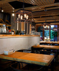 Farmhouse Rustic Chandelier With Antique Geometric Industrial Design in cozy restaurant setting, bronze finish, four-light fixture