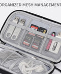 Open Waterproof Travel Cable Organizer Pouch With Double Layer Storage For Cords Chargers Phones And Earphones showing mesh compartments.