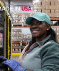Smiling factory worker in teal cap and gloves at production line, with Made in USA text and stacked boxes in background.