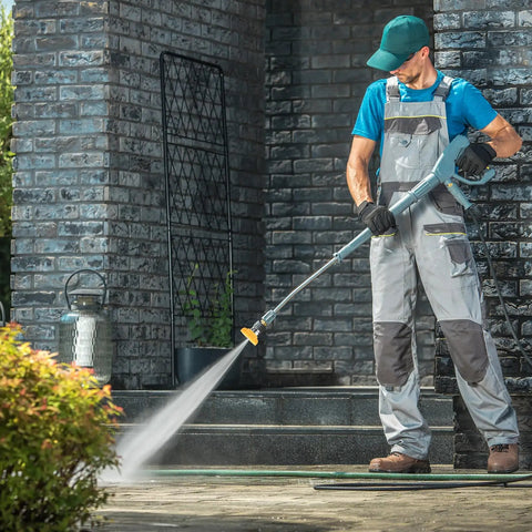 Person using pressure washer with Five Pack Pressure Washer Nozzle Tips With 1 Quarter Inch Quick Connect, Handles Up To 4000 PSI And 2.5 GPM on patio