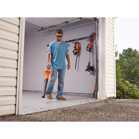 Person using Cordless Sweeper With Power Boost For Quick Yard Cleanup On Driveways Decks And Garages Includes Battery And Charger 20V Max Leaf Blower Style Tool For Debris Removal in garage