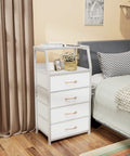 Tall 4 Drawer Dresser With Wood Top And Sturdy Steel Frame For Bedroom Or Hallway Storage Vertical Storage Nightstand Organizer In White Great For Closets Nurseries And Entryways With Space Saving Design And Easy Setup next to bed with decor on top
